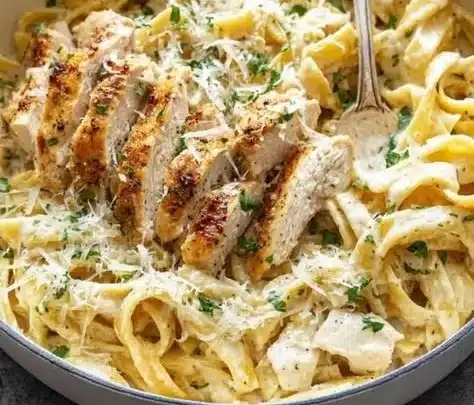Creamy Chicken Alfredo pasta dish garnished with parsley on a plate