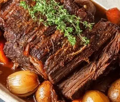 Delicious Chuck Roast Pot Roast served with vegetables and gravy