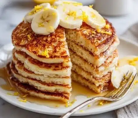 Easy Cottage Cheese Pancakes 5 Delicious homemade easy cottage cheese pancakes stacked on a plate.