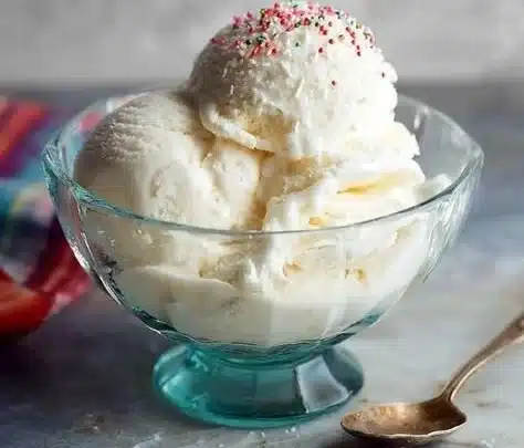 A bowl of guilt-free vanilla ice cream topped with fresh berries.