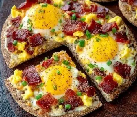 Delicious simple breakfast pizzas topped with eggs, cheese, and veggies