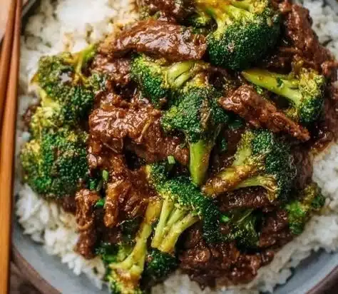 Chinese Beef and Broccoli 25 Delicious plate of Chinese Beef and Broccoli with vibrant vegetables and tender meat.