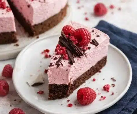 Delicious Chocolate Raspberry Mousse Cake with a rich chocolate layer and raspberry topping