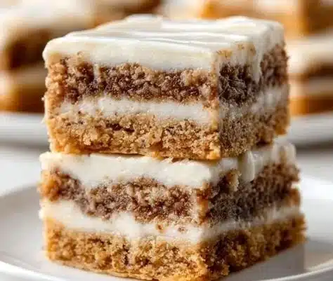 Cinnamon roll bliss bars topped with icing and cinnamon crumble