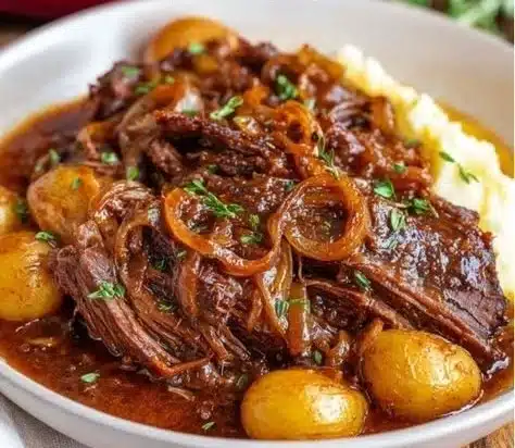 Delicious French Onion Pot Roast served with caramelized onions and herbs