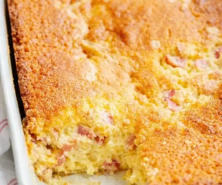Delicious slice of Rhubarb Custard Cake with a golden crust and vibrant rhubarb topping.