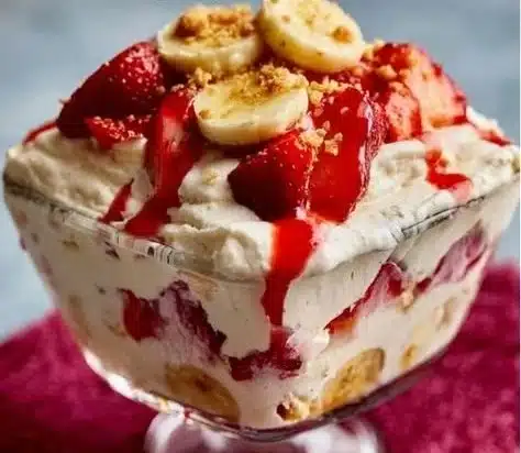 Delicious strawberry banana pudding in a dessert bowl with fresh strawberries
